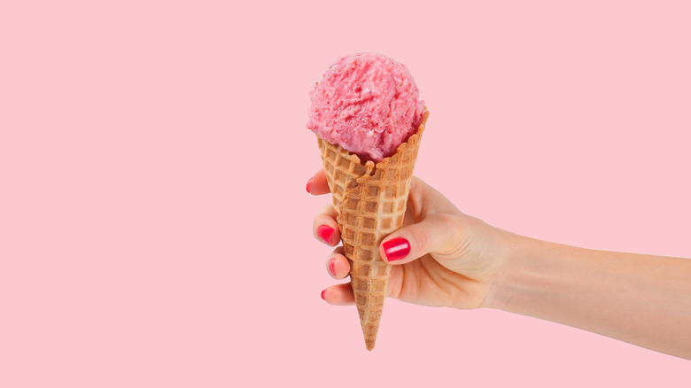 Hand holding pink ice cream