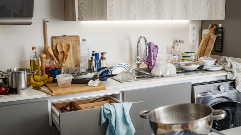 kitchen counter cluttered with objects