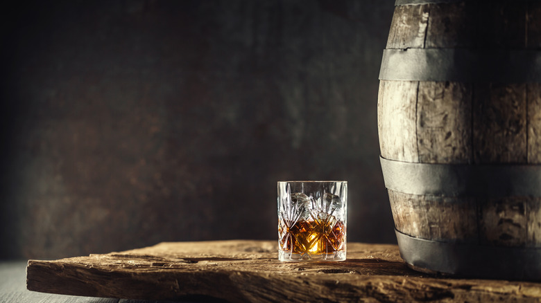 A glass of bourbon, and barrel