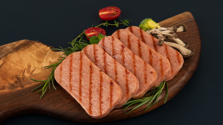 cooked Spam sliced on cutting board