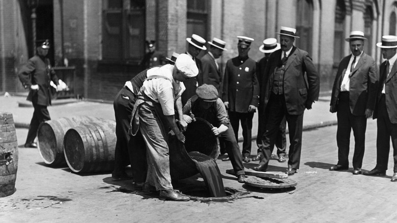 Workers pouring wine down New York sewers during the Prohibition era