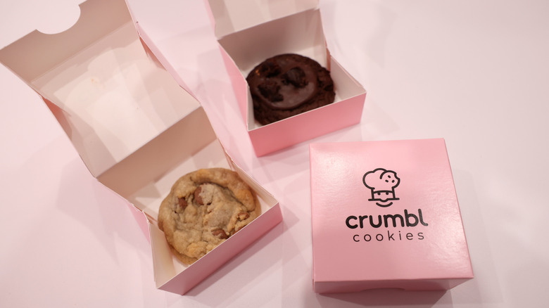 one closed and two open Crumbl cookie boxes
