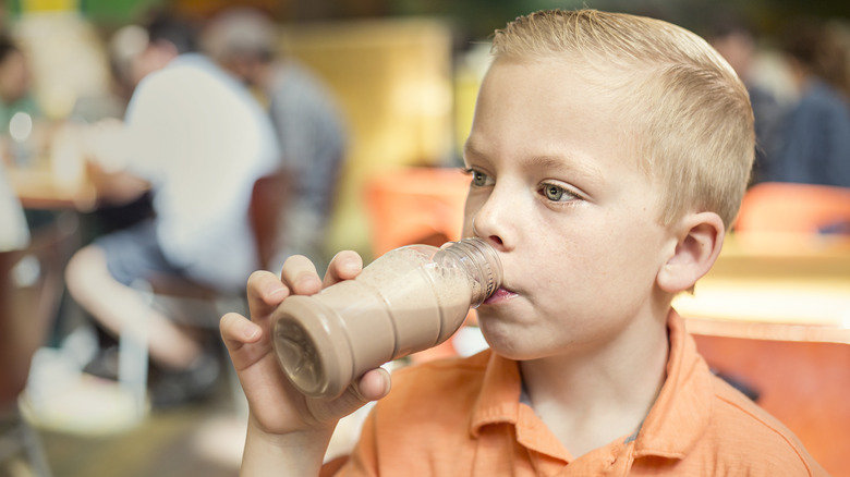 Child drinking chocolate milk at school