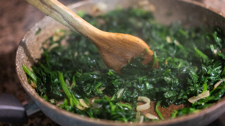 spinach being cooked in pan
