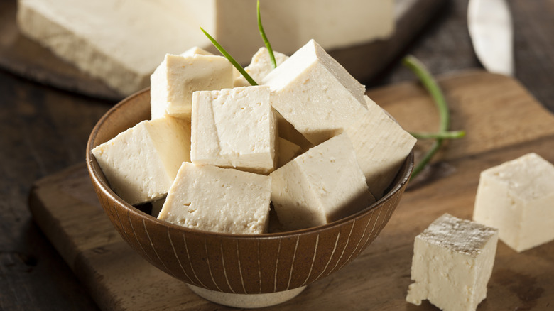 Raw tofu in brown bowl on table