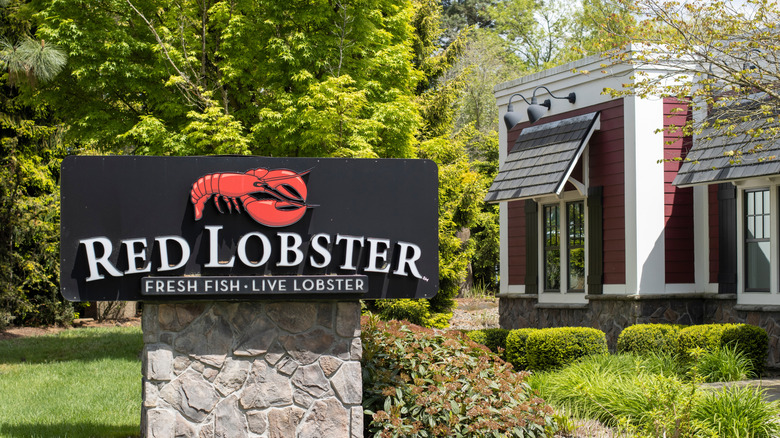 Red Lobster sign in front of building and greenery
