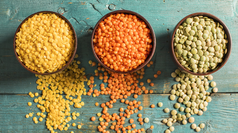 yellow, red, and green lentils in three different bowls
