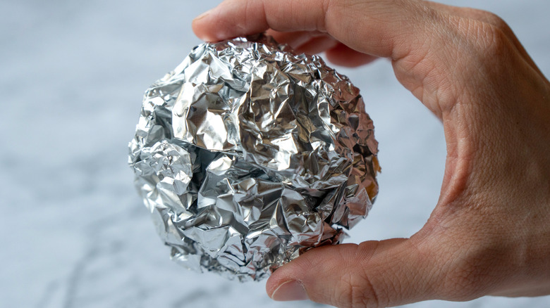 Aluminum foil rolled into a ball.