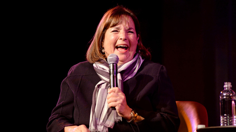 Ina Garten holding a microphone and laughing