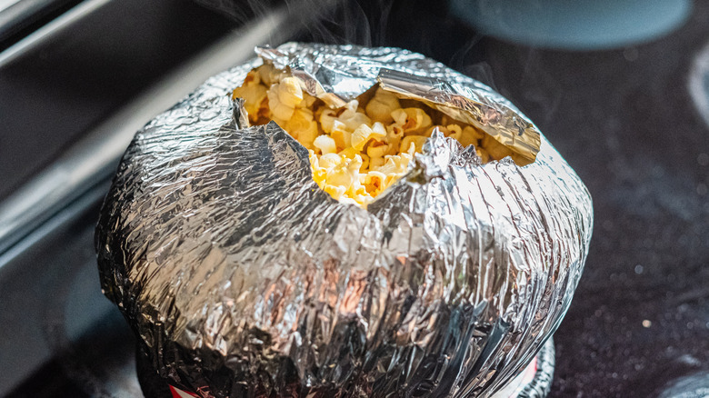 Foil ball of popcorn on stove