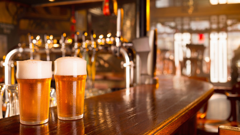 Two glasses of beer on bar