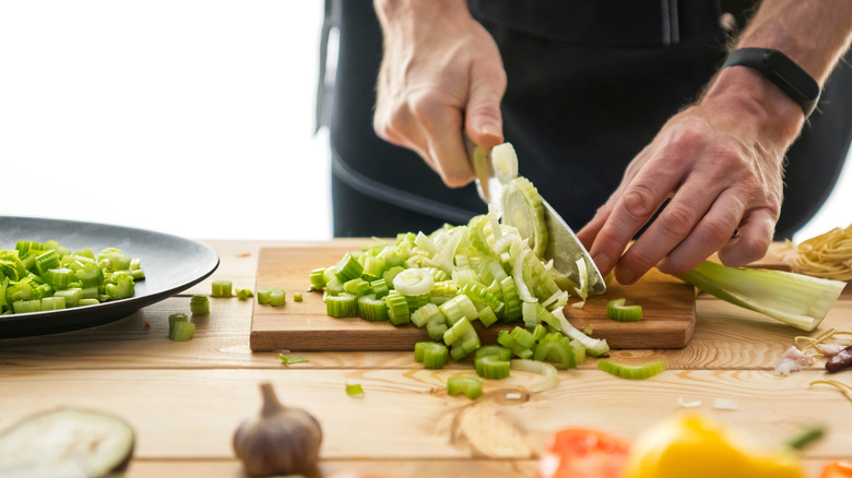 Person chopping celery