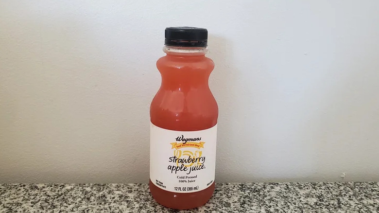 A bottle of Wegmans strawberry apple juice.