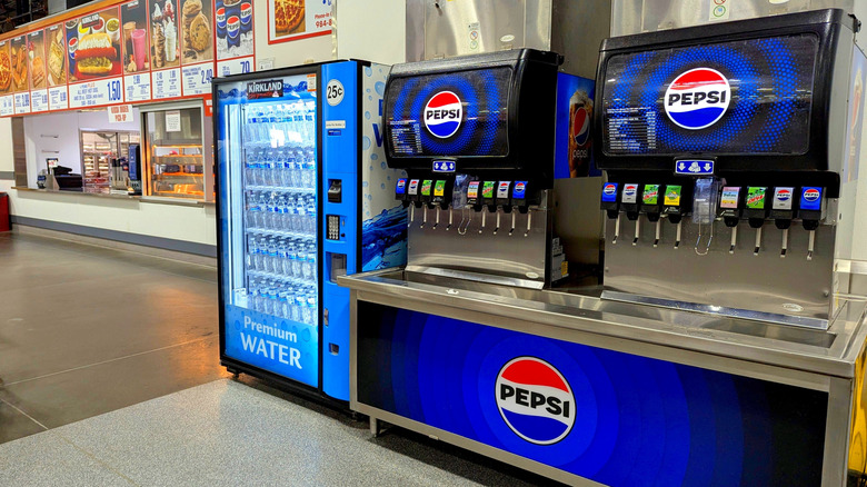 View of Costco food court's soda fountains with the ordering counter in the background