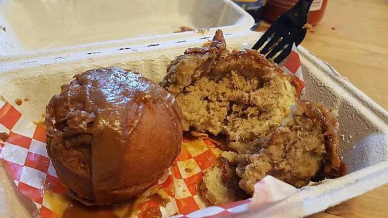 Peanut butter meatballs with sauce in tray.