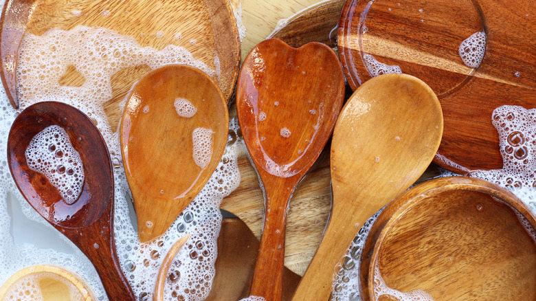 Wooden spoons in soapy water