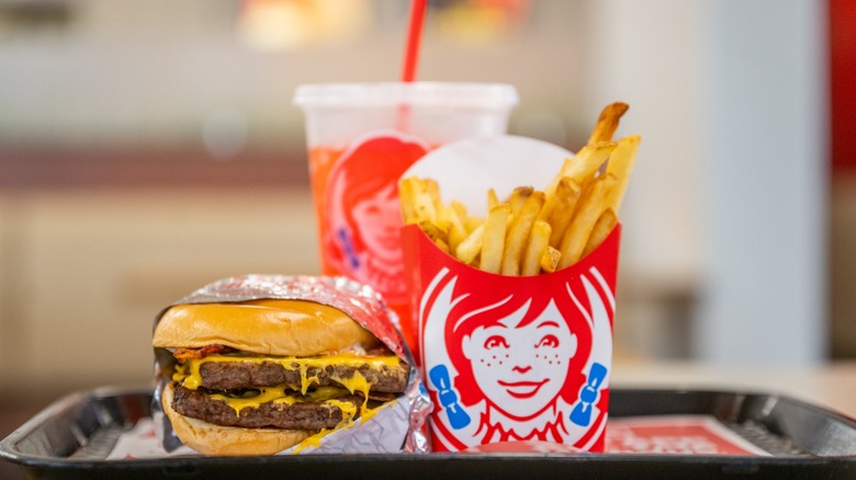 Wendy's double cheeseburger, french fries, and an orange drink