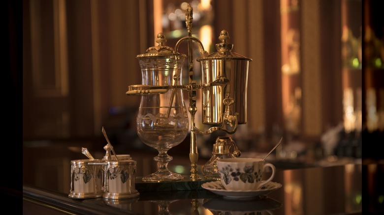 gold Royal Paris coffee maker set on table