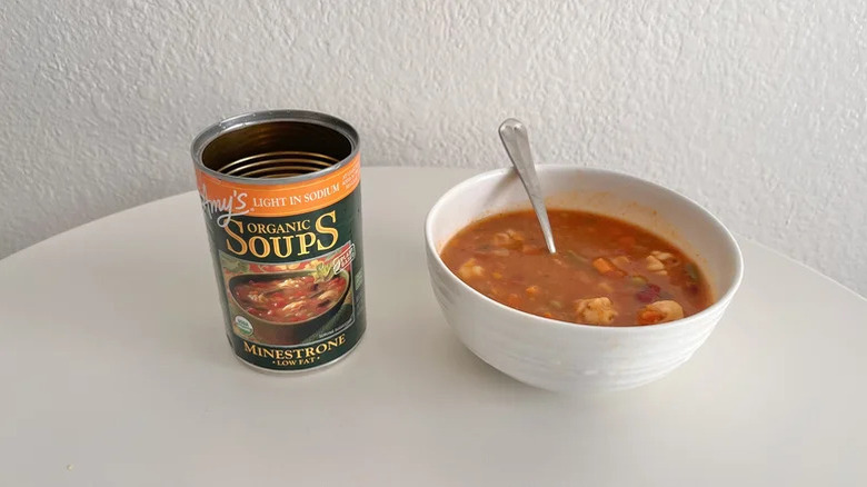 Can of Amy's minestrone soup next to a bowl of it