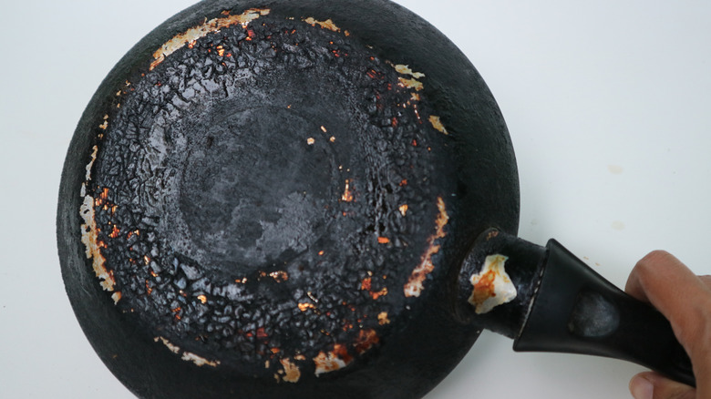 The burned black bottom of a frying pan