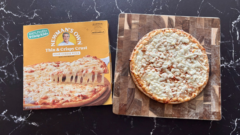 Newman's Own four cheese pizza cooked on a cutting board