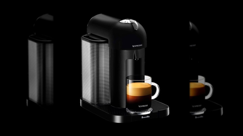 Matte black Nespresso Breville Vertuo machine on a black background