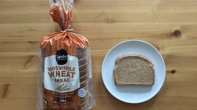 signature select loaf of whole wheat bread and a slice on the plate