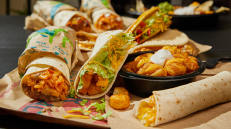 Selection of Taco Bell items including a double decker taco, a cheesy potato bowl, a potato taco, a layered burrito, and more