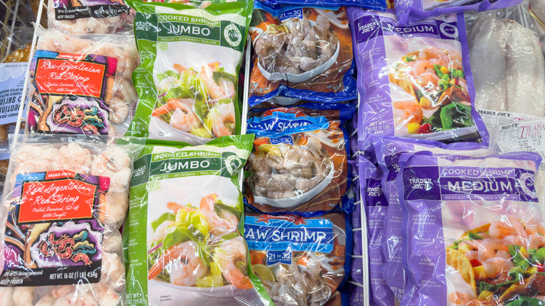 Bags of frozen shrimp in a freezer at Trader Joe's