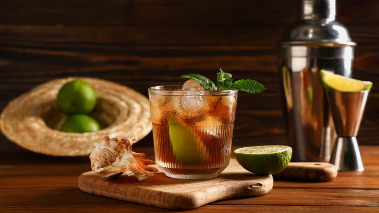 Rum cocktail in a glass with mint and limes