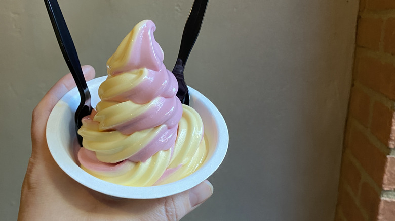 Hand holding a Dole Whip soft serve swirl at Disneyland
