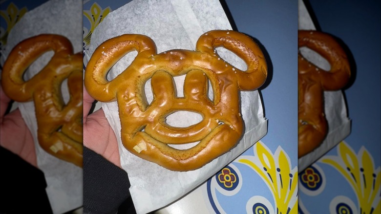 Hand holding a Mickey pretzel