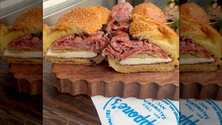 Salami, artichoke, and mozzarella sandwich on a wooden board
