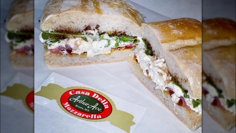 Sandwich with fresh mozzarella on paper with a Casa Della Mozzarella sticker