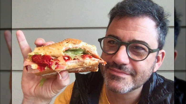 Jimmy Kimmel holding a hero from Defonte's