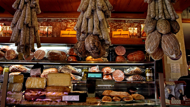 Deli counter with an assortment of cured meats and cheeses