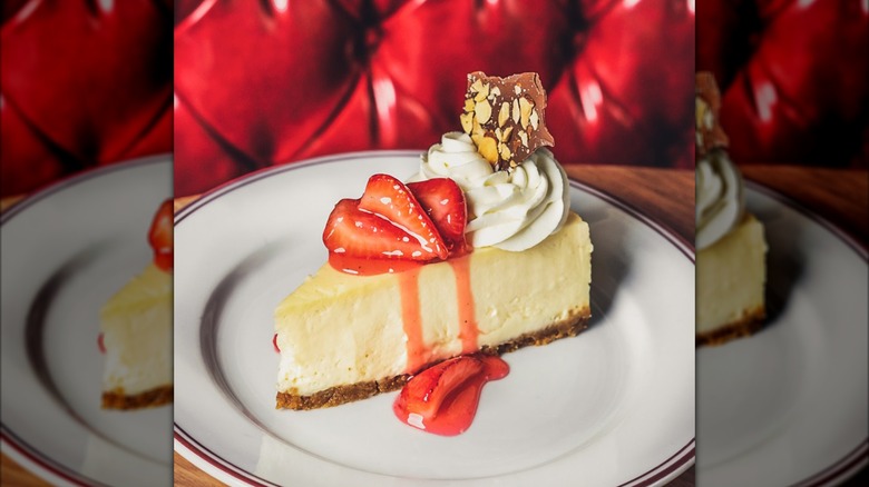 Slice of cheesecake with strawberries and cream