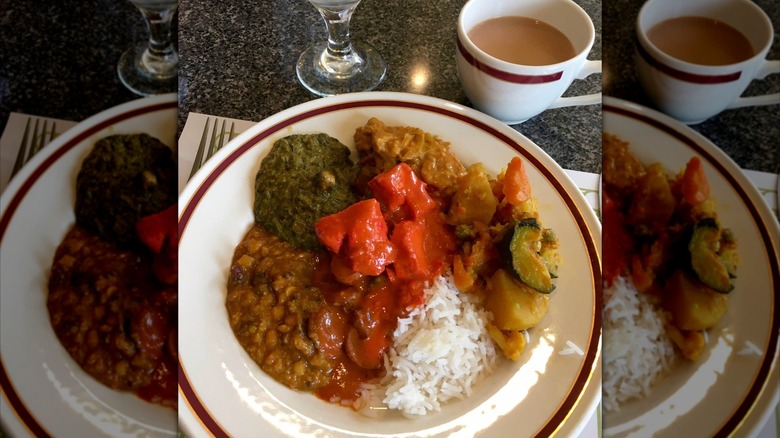 Plate of Indian food  with coffee cup and glass