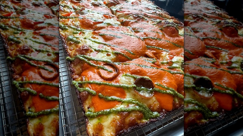 Detroit-style pizza on a metal baking rack