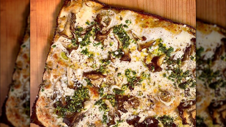 Detroit-style pizza with mushrooms on a wooden table