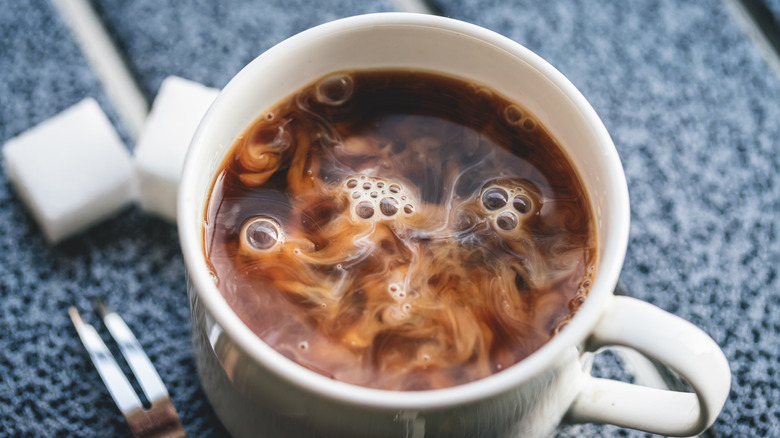 Closeup of a cup of coffee with cream