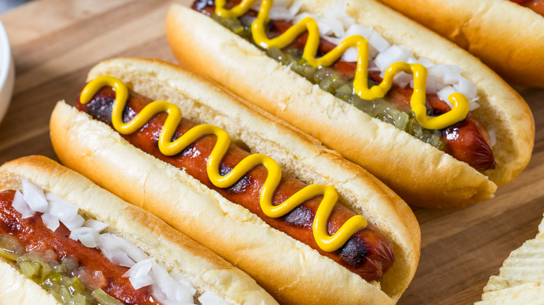 hot dogs with mustard and relish toppings