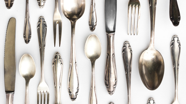 Beautiful sterling cutlery collection on white background