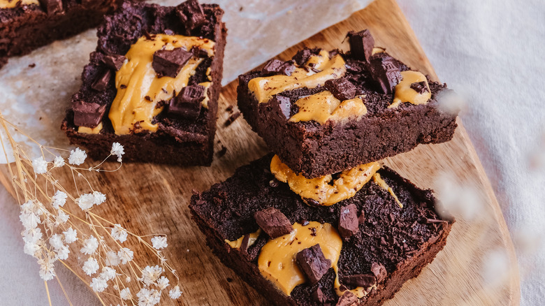 chocolate and peanut butter brownies on a wood cutting board