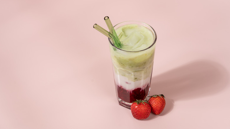 Iced strawberry matcha latte in a clear glass
