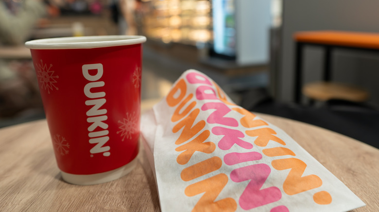 dunkin cup next to food bag