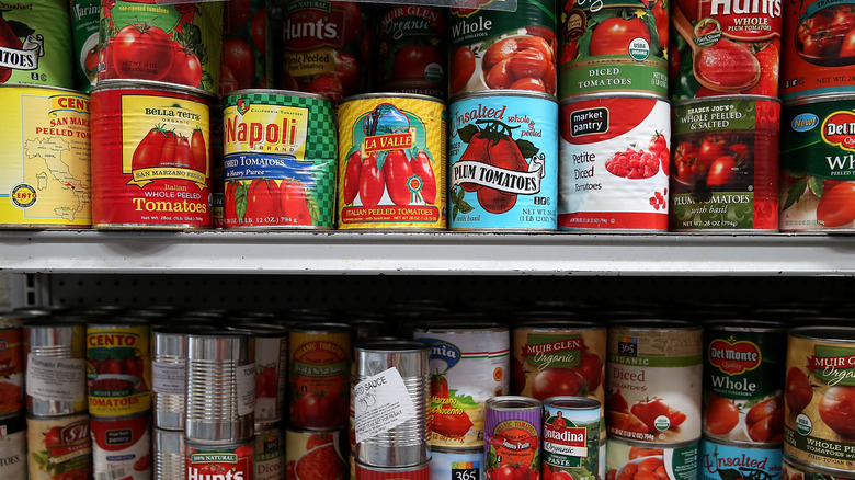 Shelf of various canned tomatoes