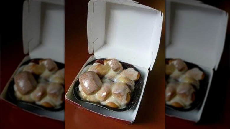 Close up of McDonald's Cinnamon Melts with icing in plastic tray
