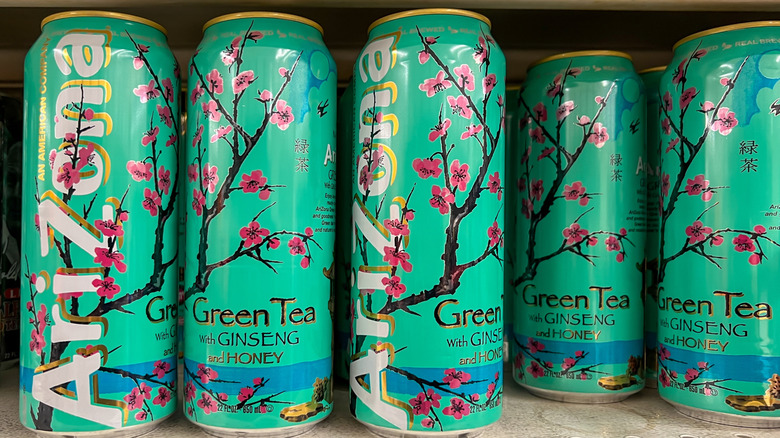 AriZona tea cans lined up on shelf at store