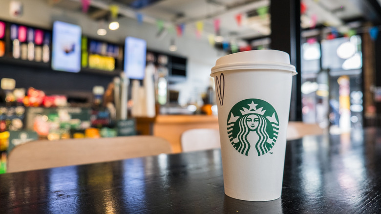 Starbucks cup sitting on a table at a Starbucks location
